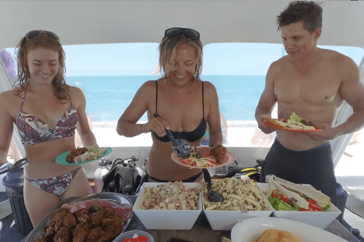 a group of people sitting at a table with a plate of food