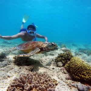 a man standing next to a body of water